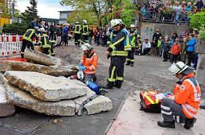 Das Rote Kreuz  und die Feuerwehr versuchen gemeinsam, einen unter Betonplatten begrabenen Verletzten zu befreien. Foto: Stephan Hübner