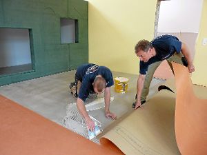 Rainer Beiter und sein Mitarbeiter Daniel Michel verkleben aktuell den Linoleum-Boden. Das Gebäude erstrahlt schon in freundlichen Farben, die den Kindern gefallen werden. Foto: Falke Foto: Schwarzwälder-Bote