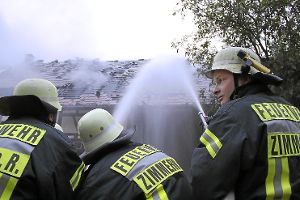Mit vereinten Kräften gehen die Feuerwehrleute aus Zimmern ans Werk, um den Brand in Flözlingen zu löschen.  Foto: Schulz