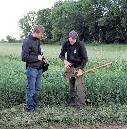 Adrian Schmid (Biolandwirt) und  Jonathan Kern  von Bioland (rechts) machen die Spatenprobe eines Linsen-Hafer-Gemenges. Ergebnis:   Boden mit guter Durchwurzelung Foto: Hölsch Foto: Schwarzwälder-Bote