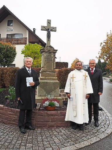 Herbert Hermle, Pater Bala und Karl-Heinz Bucher (von links) vor dem sanierten Rombergle-Kreuz.  Foto: Hölsch Foto: Schwarzwälder-Bote