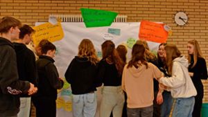 Die Jugendlichen arbeiten in der Aula ihre Wünsche und Vorschläge an der „Wall of wish“ aus. Foto: Baur