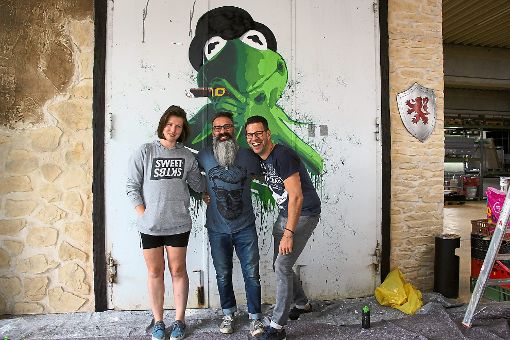 Die Graffittikünstlerin Ani (links) gestaltet das Stahltor von Coskun Alin (Mitte) und seinem Vermieter Mark Deneberger. Foto: Thiercy Foto: Schwarzwälder-Bote