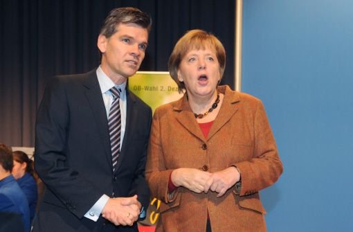 Bundeskanzlerin Angela Merkel (CDU) und Ingo Wellenreuther (CDU), Kandidat für die Oberbürgermeisterwahl in Karlsruhe Foto: dpa