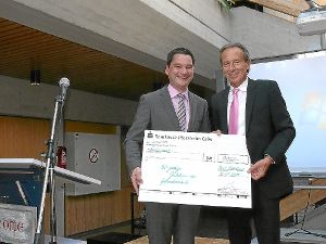 Bürgermeister Klaus Mack (links) übergab Rektor Bernd Döhring als Geschenk der Stadt Bad Wildbad einen symbolischen Spendenscheck mit einem Betrag von 1000 Euro. Foto: Schwarzwälder-Bote