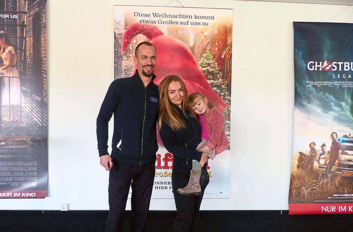 Julian Müller, Kinobetreiber der BlueBoxx in Villingen steht mit seiner Frau Katharina und der vierjährigen Tochter Viktoria vor Filmplakaten – sie versuchen trotz allem optimistisch zu bleiben. Foto: Kupferschmidt