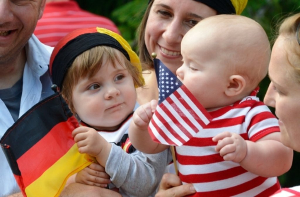 Ein junger US-amerikanischer Fußballfan und und ein junger deutscher Fan schauen gemeinsam mit ihren Eltern beim Public Viewing in den Patch Barracks in Stuttgart das WM-Spiel der Deutschen gegen die USA an. Foto: dpa