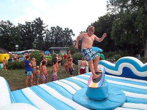 Auf einem Hindernisparcours im Wasser, einer Hüpfburg oder beim Rodeo Surf Riding vergnügen sich die jungen Besucher bei der Pool-Party im Geislinger Schlossparkbad. Foto: Schnurr