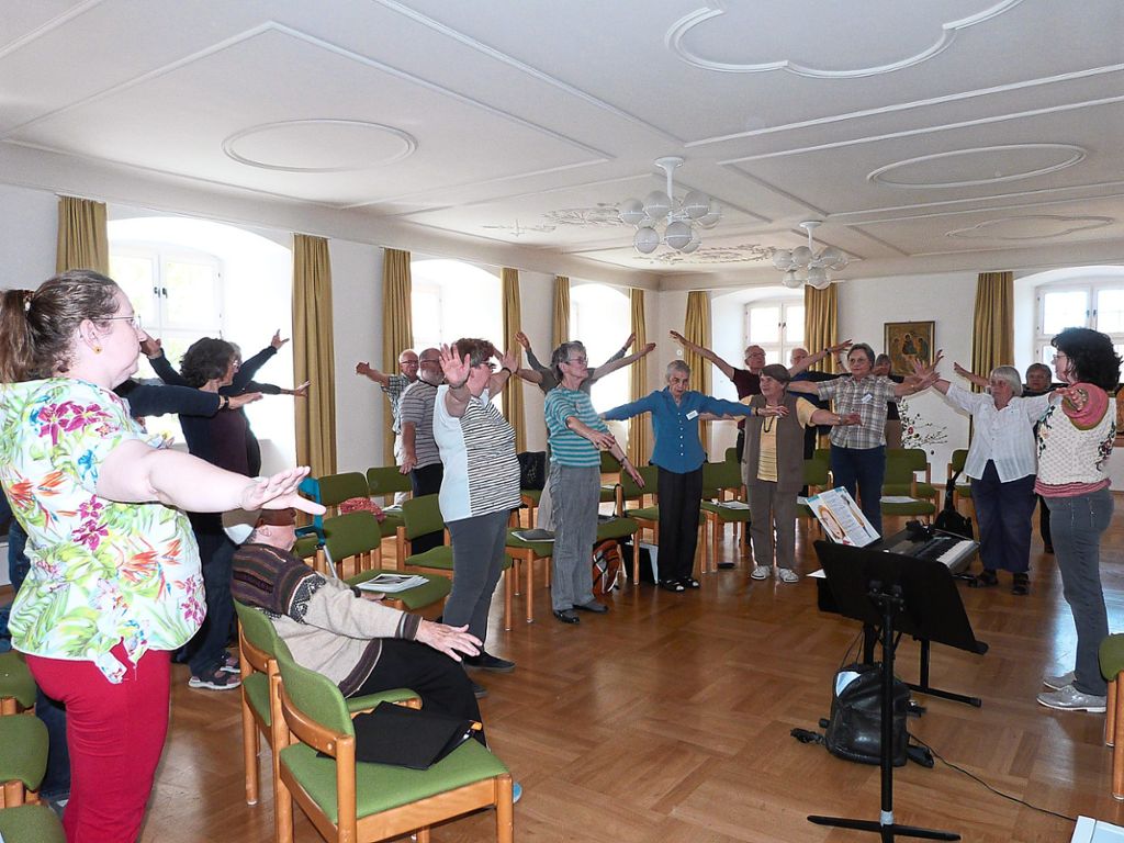 Die Mitglieder des Ostersingerchors wärmen sich beim Auftakt gemeinsam auf, angeleitet von Stimmbildnerin Claudia Echle. Fotos: Merk
