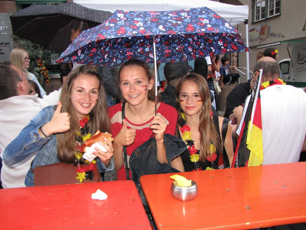 Drei Damen unterm Schirm: Der Regen tat der Stimmung keinen Abbruch, und die Schminke blieb trocken.  Foto: Wölfle