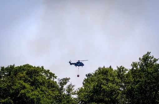 Ein Hubschrauber wirft Löschwasser zur Bekämpfung eines Waldbrands in Mecklenburg-Vorpommern  ab. Foto: dpa/Jens Büttner
