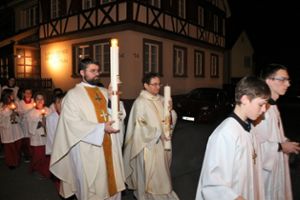 Pater Mateusz Jaszcyk (links)  und Pater Artur Schreiber weihten in der Osternacht die Osterkerzen und trugen sie in die Kirche.  Foto: Wahl Foto: Schwarzwälder Bote
