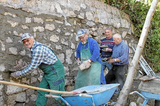 Schwer im Einsatz: Die Rentnergruppe aus Göschweiler besserte die Mauer des Göschweiler Pfarrhauses aus.  Foto: Bächle Foto: Schwarzwälder-Bote