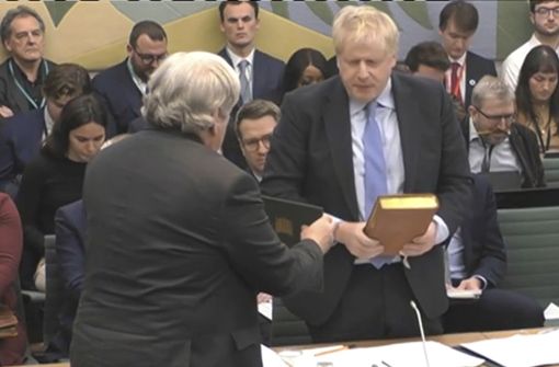Der ehemalige Premierminister Boris Johnson legt vor seiner Aussage vor dem Privilegienausschuss des Unterhauses einen Eid ab. Foto: House of Commons/UK Parliament/UK Parliament/AP/dpa