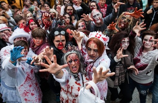 Gruselig ging’s am Samstag in der Stuttgarter Innenstadt zu: Mehrere hundert Menschen verkleideten sich beim Zombie-Walk und erschraken ahnungslose Passanten. Foto: dpa