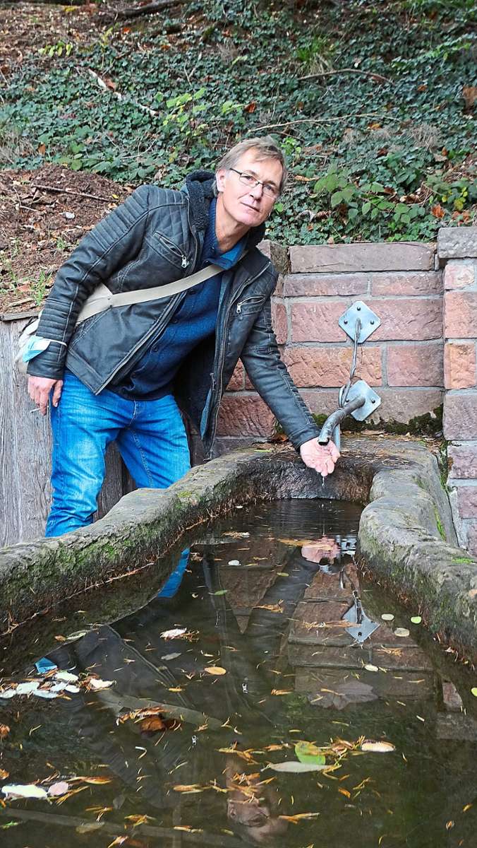 Volker Müller zeigt das spärliche Rinnsal des Gieseneckbrunnens.  Foto: Fischer