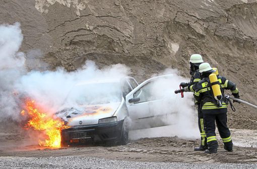 Löscharbeiten am Auto, das Feuer gefangen hatte. Foto: Lenski