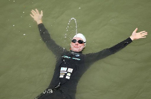 Andreas Fath schwimmt am Mittwoch im Rhein zwischen Wiesbaden (Hessen) und Mainz. Foto: dpa