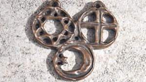 Symbole der drei großen Religionen in einem Amulett vereint
