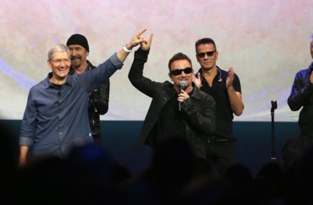 Apple-Chef Tim Cook (links) mit dem Sänger der irischen Rockband Bono (dritter von rechts) bei der Keynote in Cupertino.