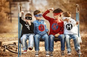 Vier kleine Superhelden beim Muskelvergleich. Foto: Adobe Stock/Alexandr Vasilyev