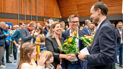 Noch-Bürgermeister Marcel Hagenlocher (rechts)  gratuliert seinem frischgewählten Nachfolger Benjamin Finis sowie dessen Frau und zwei von dessen drei Kindern. Foto: Thomas Fritsch